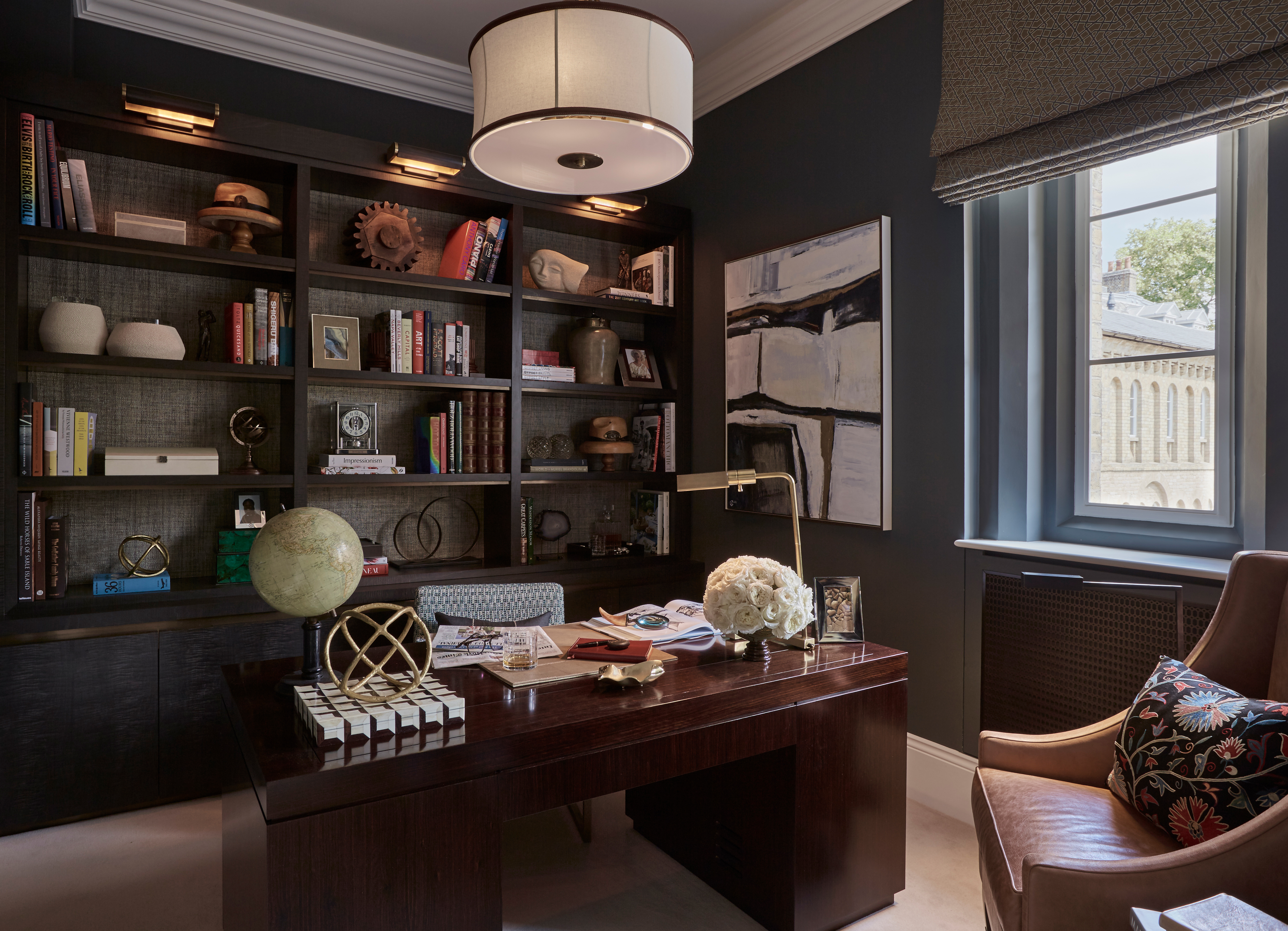 Luxury home office with bespoke desk and armchair with joinery unit