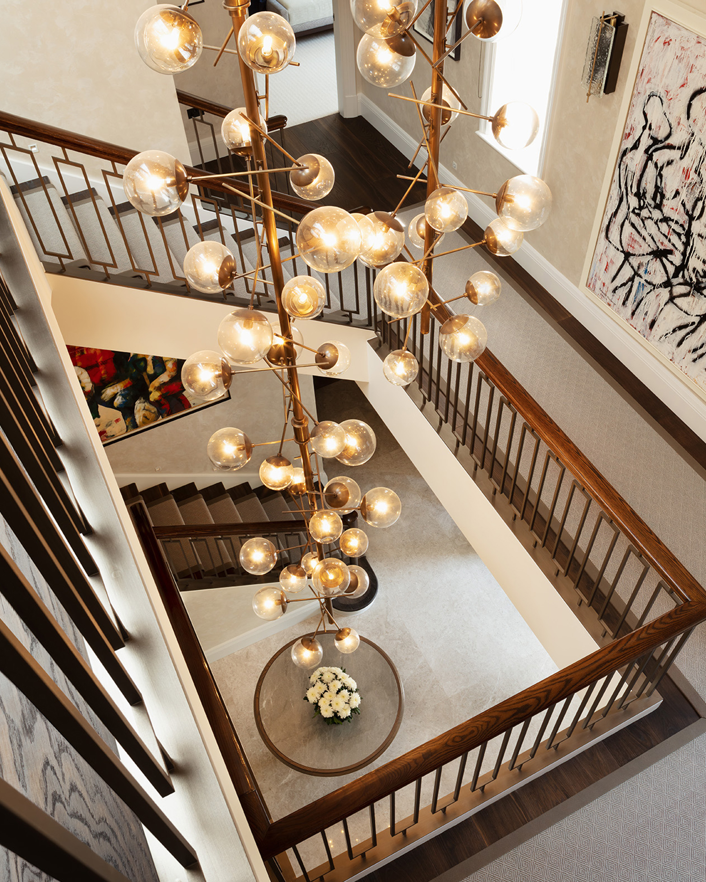 Dramatic chandelier in entrance hall floating down three storeys.